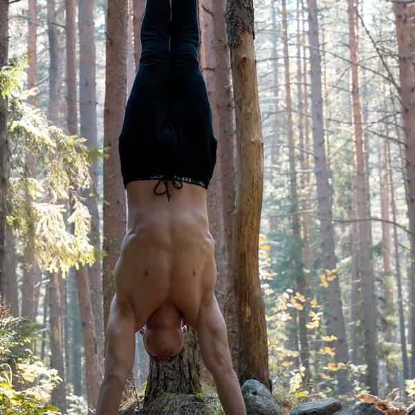 Man stretching outdoors at sunrise, feeling energized and full of life.